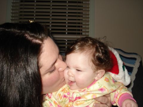 2000 Ford Crown Victoria - A tender moment between a woman and a baby, captured in a warm embrace.