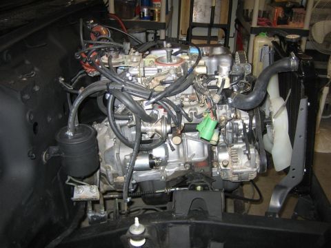1987 Suzuki Samurai - Engine bay view showing the engine, radiator, and fan assembly.