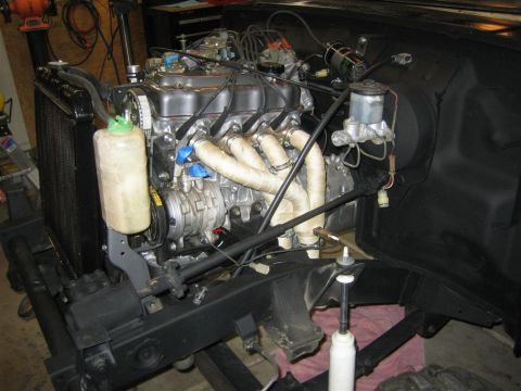 1987 Suzuki Samurai - The engine and surrounding components are visible in this close-up shot of a vehicle's engine bay.