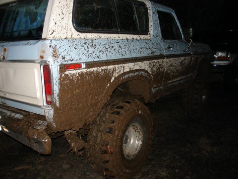 1978 Ford Bronco - This 1978 Ford Bronco is covered in mud after off-roading. Another vehicle is partially visible.