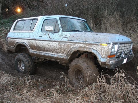 1978 Ford Bronco - This light blue 1978 Ford Bronco is navigating a challenging muddy off-road course.