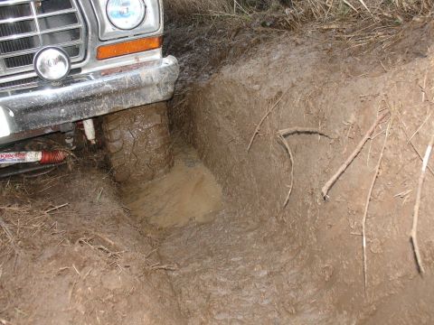 1978 Ford Bronco - This 1978 Ford Bronco is stuck in a muddy ditch, with its front tire submerged.