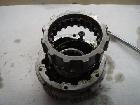 1996 Ford Bronco - Close-up of a disassembled manual locking hub assembly, showing internal gears and components.