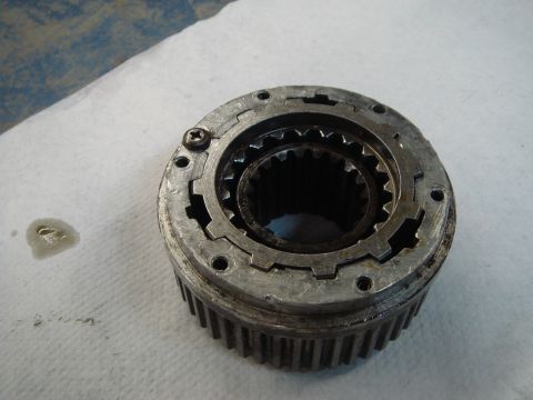 1996 Ford Bronco - A close-up view of a metal manual locking hub, showing its internal splines and external gear teeth.
