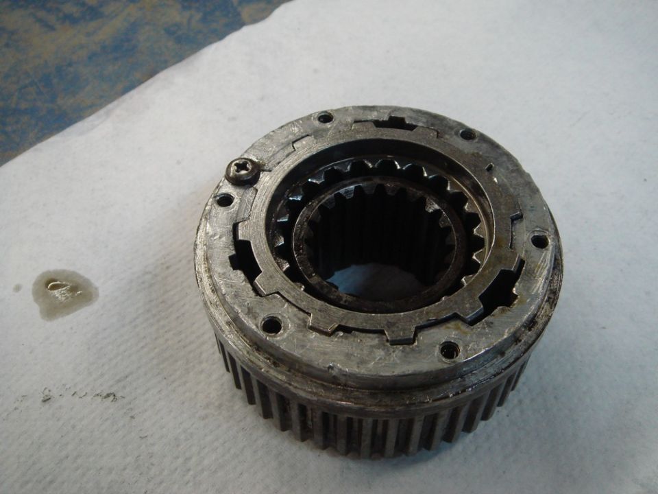 Close-up of a metal manual locking hub with splines and a screw visible