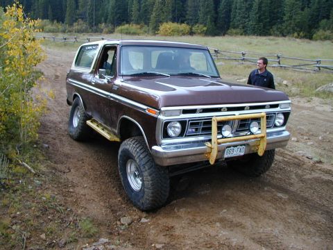 1979 Ford Bronco - This 1979 Ford Bronco features a yellow bull bar and is seen off-road on a dirt path.
