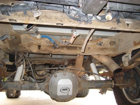 1996 Ford Bronco - The rear axle and exhaust system of a 1996 Ford Bronco are visible in this undercarriage shot.