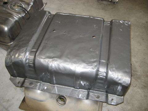 1996 Ford Bronco - Two fuel tanks are shown, one with a gray coating and the other with a polished metal finish.