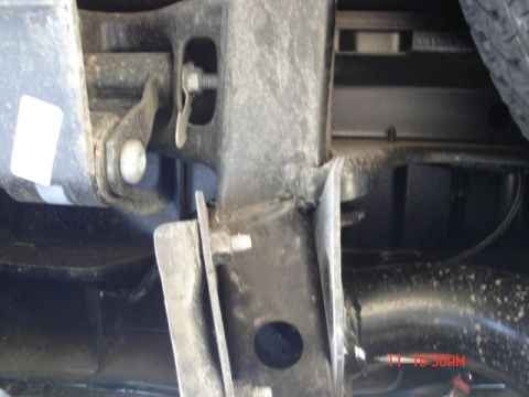 1981 Ford Bronco - Close-up view of the vehicle's undercarriage components, including suspension parts and a tire.