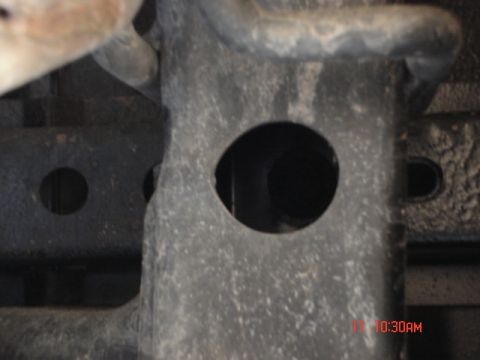 1981 Ford Bronco - Detail of a vehicle's frame structure, two distinct circular openings.
