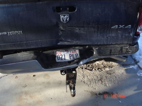 1981 Ford Bronco - The rear of a damaged pickup truck shows significant impact to the bumper and tailgate.