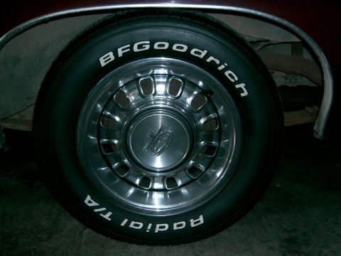 BFGoodrich Radial T/A tire on a chrome wheel with a center cap showing a '10' emblem