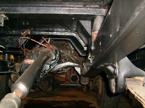1974 Ford Bronco - Underside view of a vehicle's drivetrain components, including the driveshaft and rear differential.