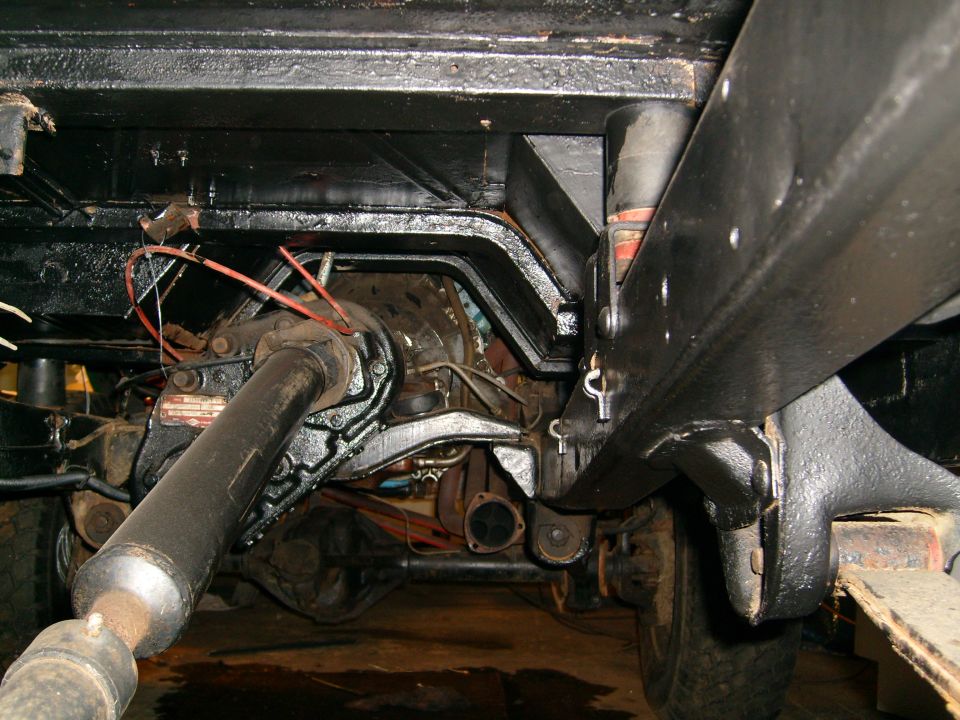 Underbody view of vehicle drivetrain, showing driveshaft and differential