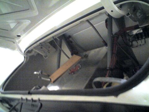 1963 Ford Fairlane - The interior of a car's trunk is shown, revealing wiring and structural components.