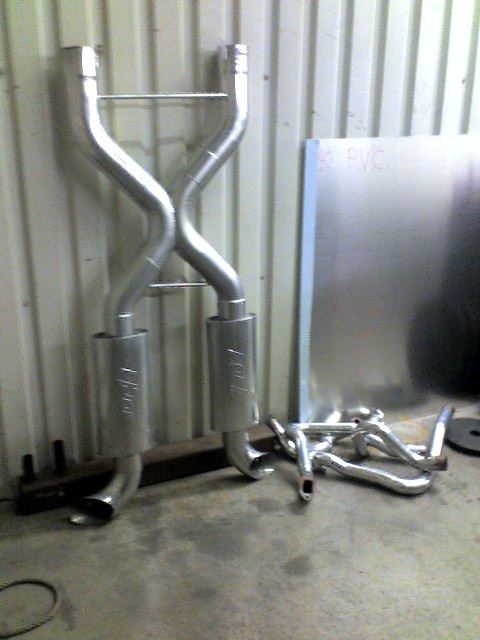 1963 Ford Fairlane - New exhaust system components are laid out, ready for installation.