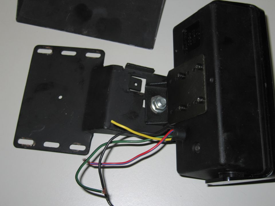 Black electronic part with wires and mounting bracket
