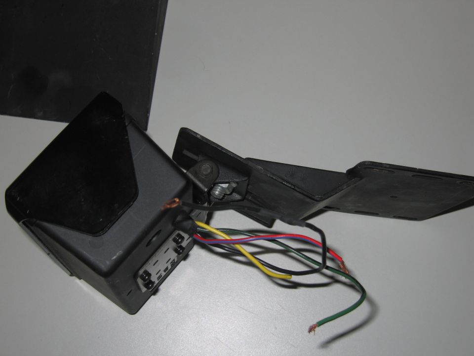 Black automotive mirror light assembly with exposed wires and connectors