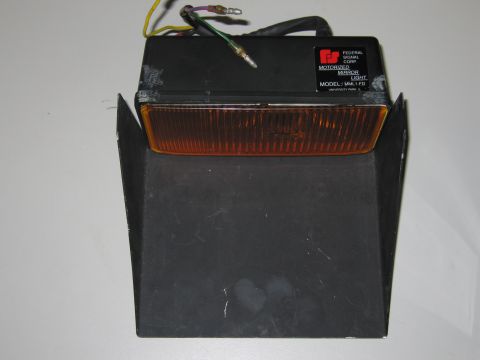 2001 Ford Crown Victoria - A Federal Signal Corporation motorized mirror light with an amber lens and visible wiring is shown against a white background.