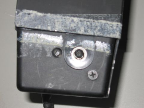 2001 Ford Crown Victoria - Close-up view of a black plastic housing with visible wear and tape residue.