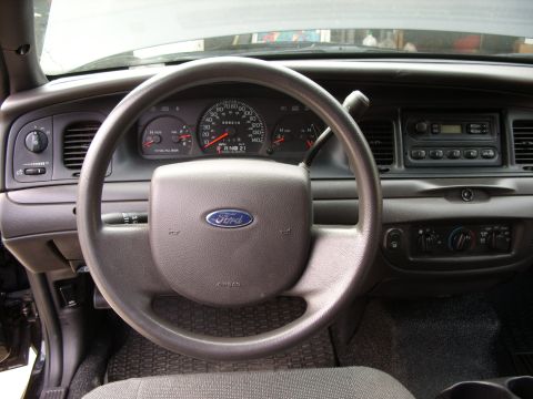 2005 Ford Crown Victoria - The interior of a 2005 Ford Crown Victoria, showing the dashboard, steering wheel, and instrument cluster.
