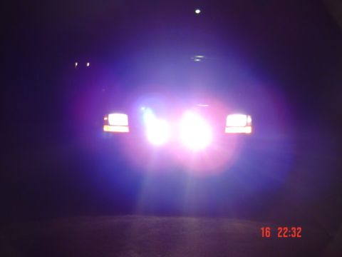 1995 Ford F-150 - Front view of a 1995 Ford F-150 with its headlights illuminated at night.