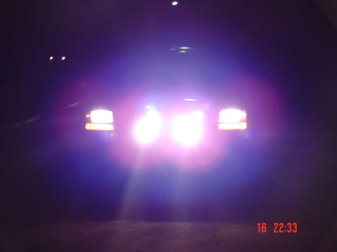 1995 Ford F-150 - The bright headlights of a truck illuminate the dark night.