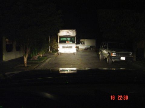 1995 Ford F-150 - A silver Jeep Cherokee is parked at night, viewed from the front.