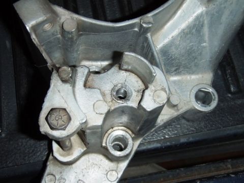 1995 Ford F-150 - Metal bracket with bolts and gears, likely a component from a larger assembly.