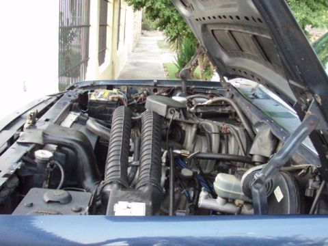 1995 Ford F-150 - The engine compartment of a 1995 Ford F-150, showing the V8 engine and associated components.