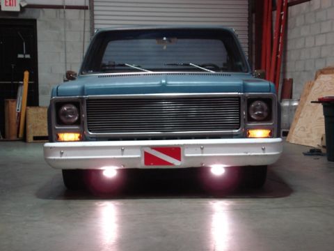 1979 Chevrolet C/K Pickup - Front view of a blue 1979 Chevrolet C/K Pickup, a custom grille and a dive flag mounted on the bumper.