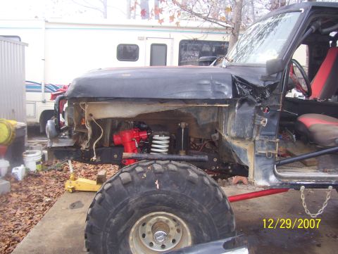 1978 Ford Bronco - Damaged black SUV with red interior and large tires sits on a concrete pad.