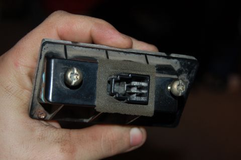 1989 Ford Probe - Close-up of a car part with a connector, held by a hand.