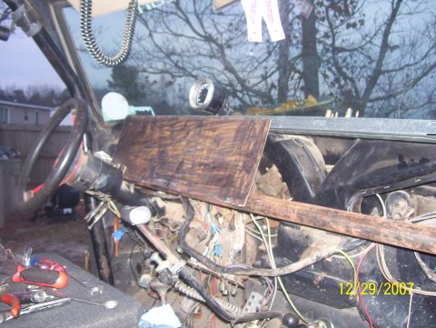 1978 Ford Bronco - The interior of a vehicle shows exposed wiring and a makeshift dashboard cover, suggesting ongoing repairs or modifications.