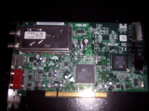1995 Ford Probe - Close-up of a green circuit board with various electronic components and connectors.