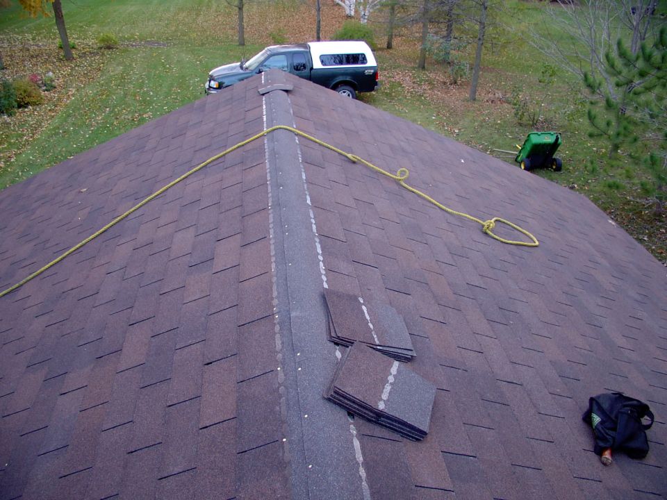 Nearly done. Used ice shield/seal instead of tar paper over the whole roof, better seal. Brother's work truck in the background. 5/12 slope for snow load and 25 year shingles double brown, like the house.
