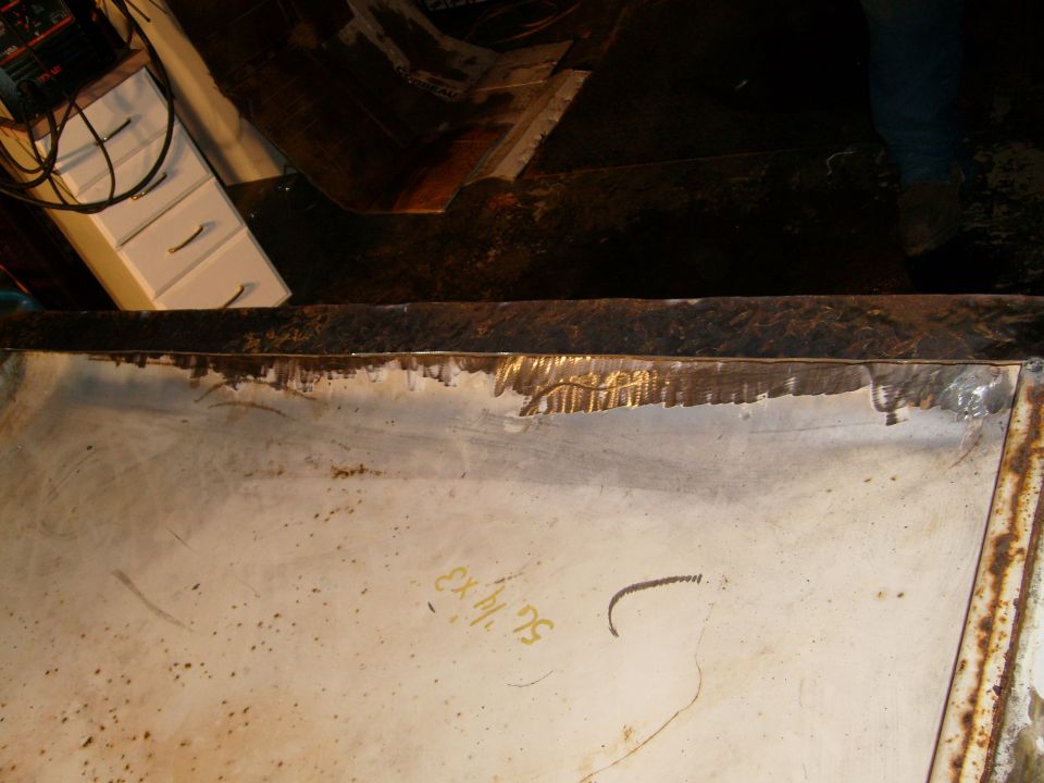 Interior of a white vehicle part with yellow writing 'EX 14 75'