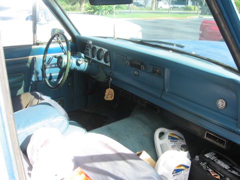 1978 Jeep Cherokee - The interior of a 1978 Jeep Cherokee shows its blue dashboard, steering wheel, and seats.