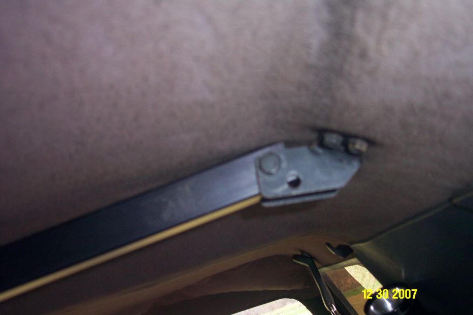 Gray headliner and black sun visor bracket inside a vehicle, dated 12 30 2007