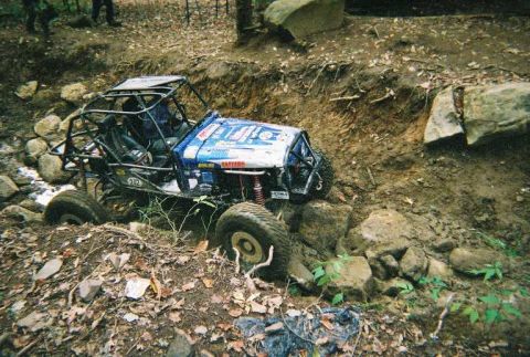 1976 Ford Bronco - This custom off-road buggy is navigating a challenging, rocky terrain with steep inclines.