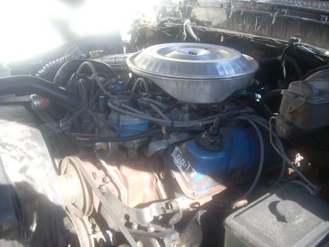 1992 Ford Bronco - Close-up view of a vehicle's engine bay, showing various components and wiring.