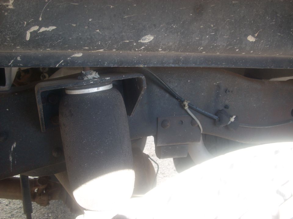 Close-up of an air suspension bellows mounted to a vehicle frame