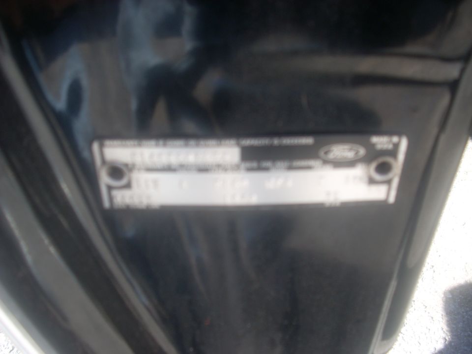 Close-up of a Ford VIN plate with some text and numbers visible