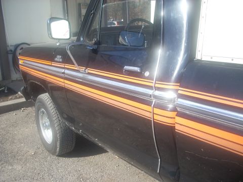 1992 Ford Bronco - This 1970s Ford F-Series truck features distinctive orange and silver side stripes.
