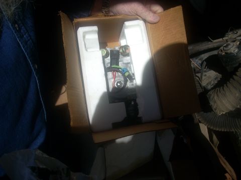 1992 Ford Bronco - A vehicle part is shown inside its original packaging, in foam within a cardboard box.