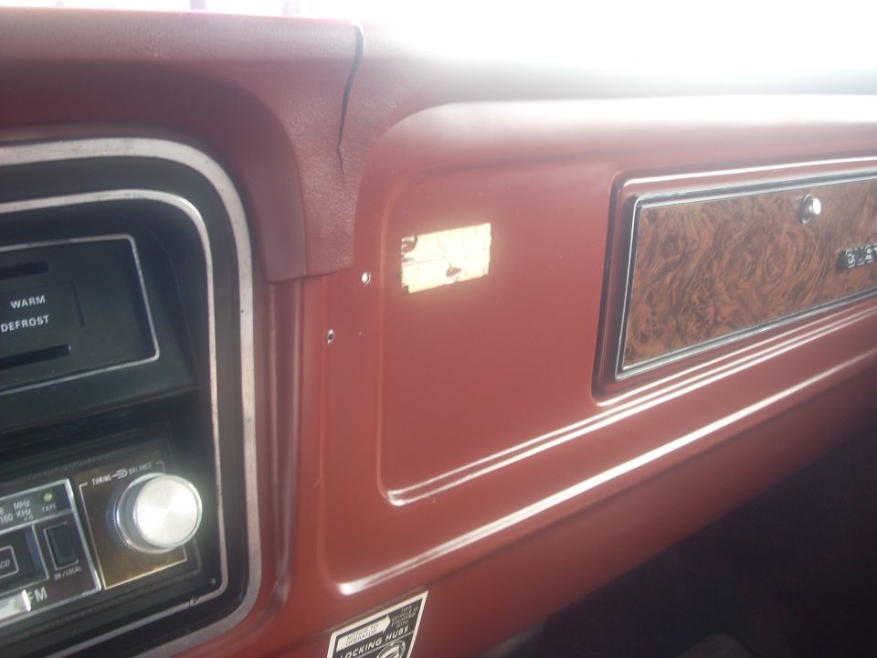 Red dashboard interior with wood grain trim and a radio