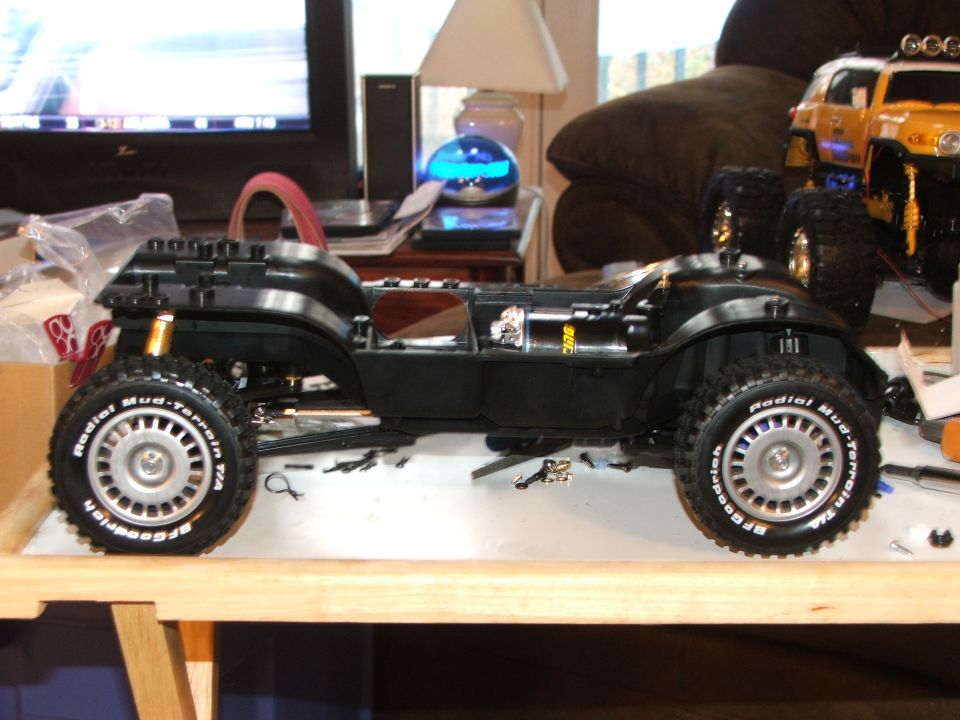 Black RC car chassis with BFGoodrich Radial Mud-Terrain tires, side view
