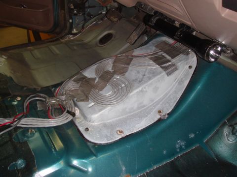1996 Ford Bronco - Vehicle interior floor pan showing wiring and a covered component, possibly for repair or modification.
