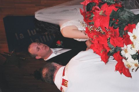 1984 Ford Bronco - A wedding ceremony scene the bride, groom, and officiant, adorned with festive poinsettias.