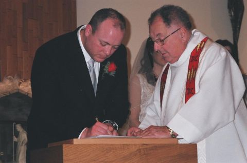1984 Ford Bronco - Wedding ceremony in progress with groom signing the marriage license.